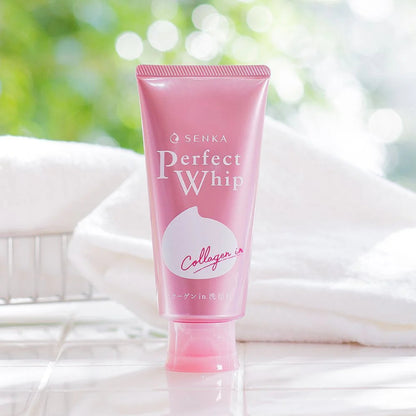 Pink tube of Senka Perfect Whip with a blurred green and white background