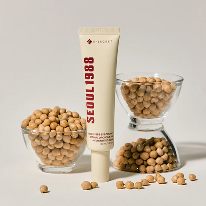 Tube of K-Secret Seoul 1988 skincare product with soybeans on a light background