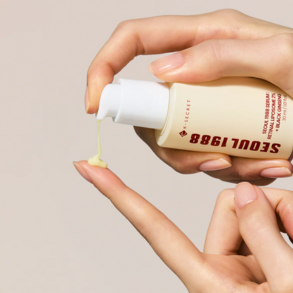Hand holding a bottle of 'Seoul 1988' skincare serum with cream being squeezed out.