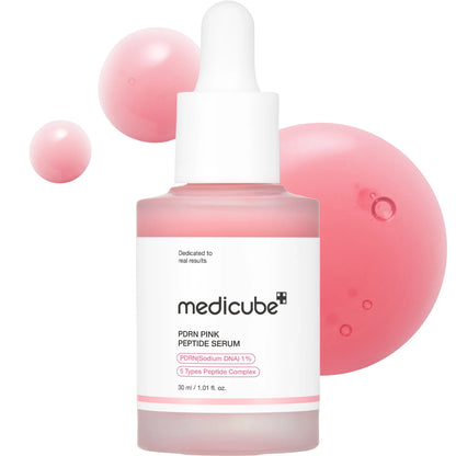 Medicube PDN Pink Peptide Serum with pink spheres on a white background