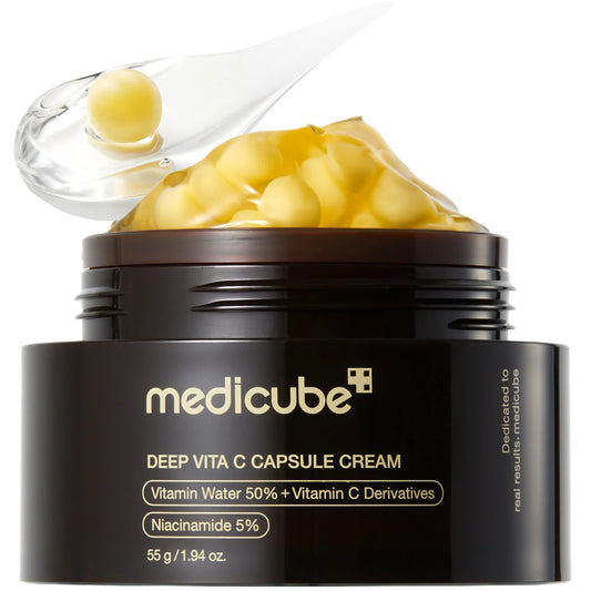 Open jar of Medicube Deep Vita C Capsule Cream with visible cream and packaging details.
