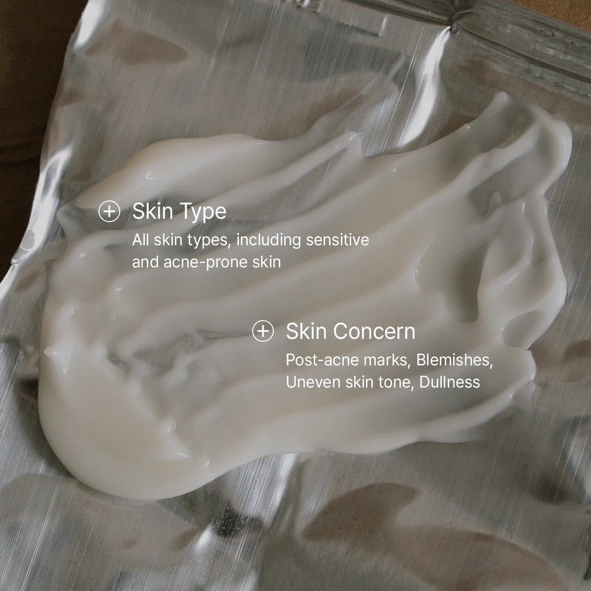 White cream on a metallic surface with text about skin type and concerns.