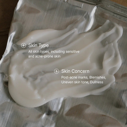White cream on a metallic surface with text about skin type and concerns.