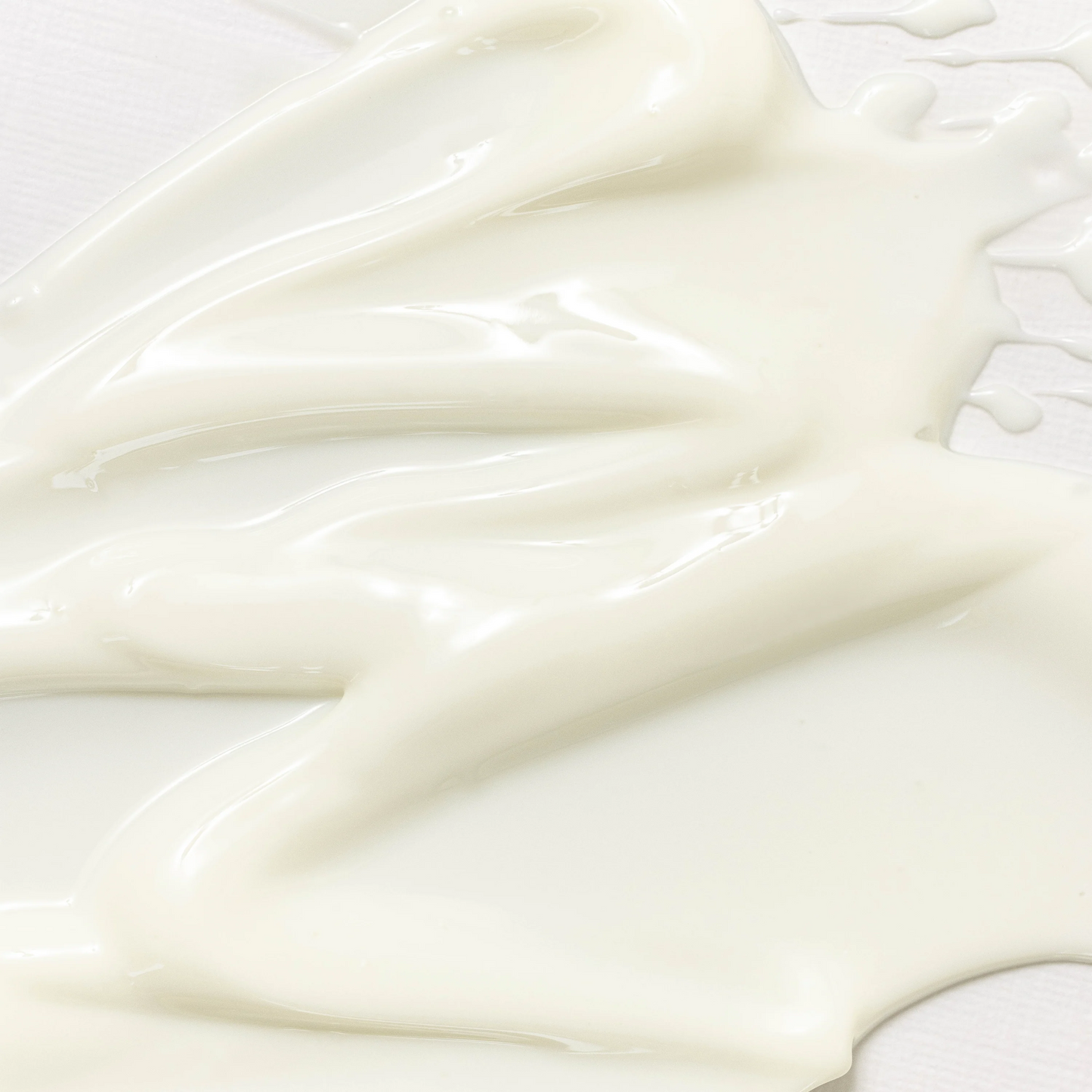 Close-up of smooth, white cream on a light background