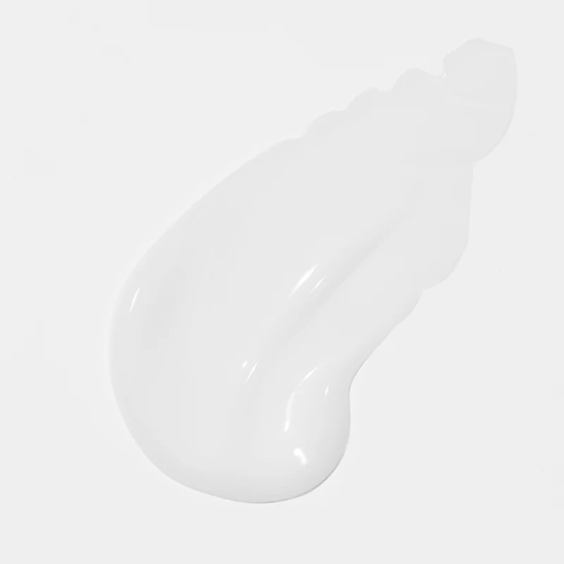 Close-up of a white cream texture on a light gray background