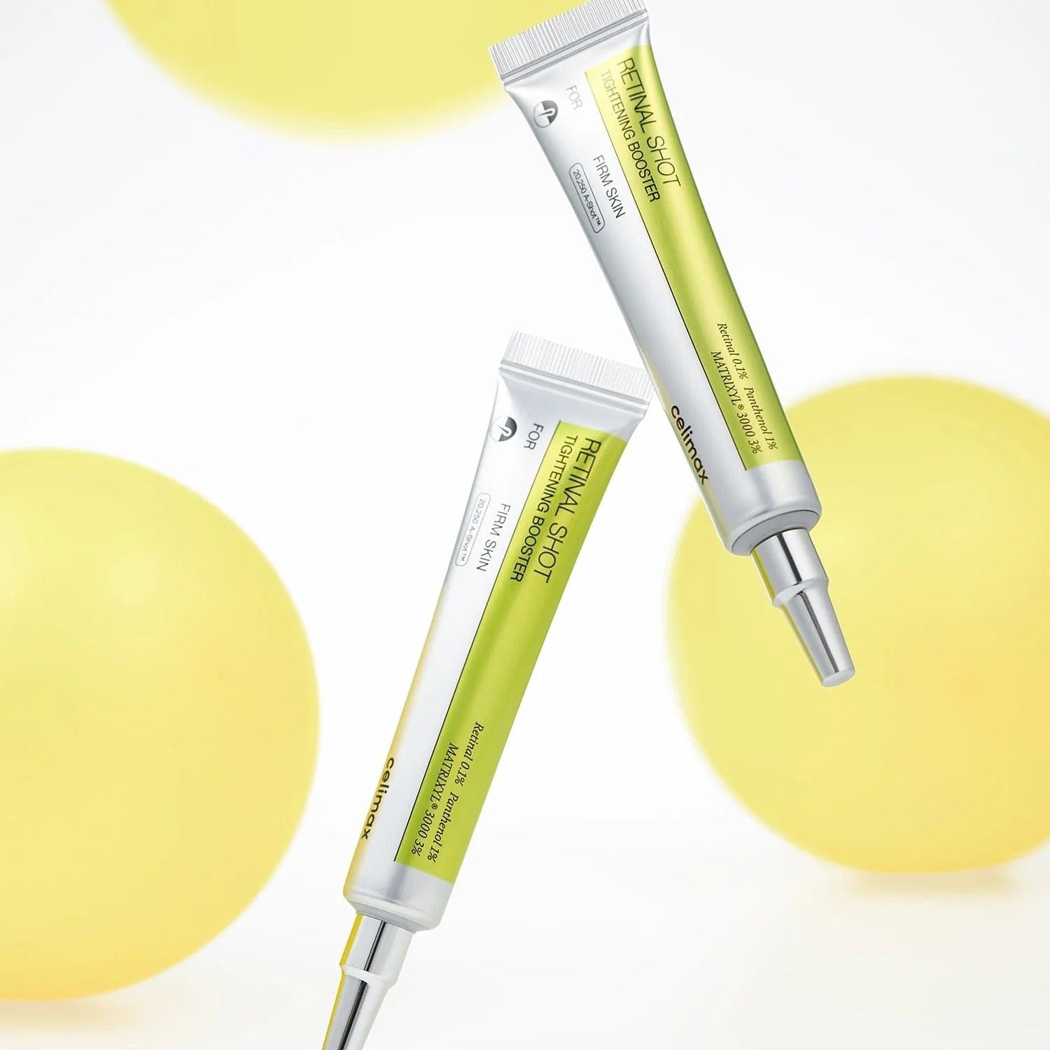 Two skincare serum tubes on a white background with yellow circles