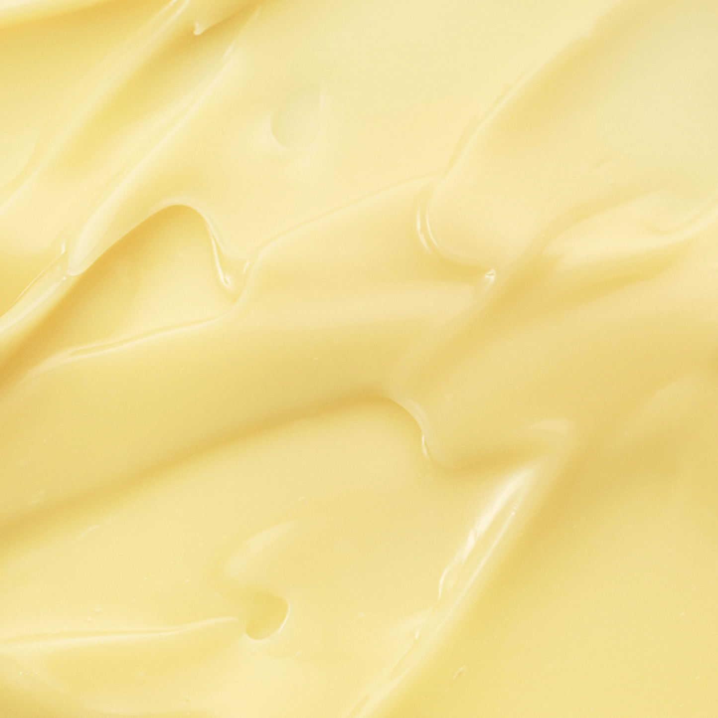 Close-up of smooth, light yellow fabric texture
