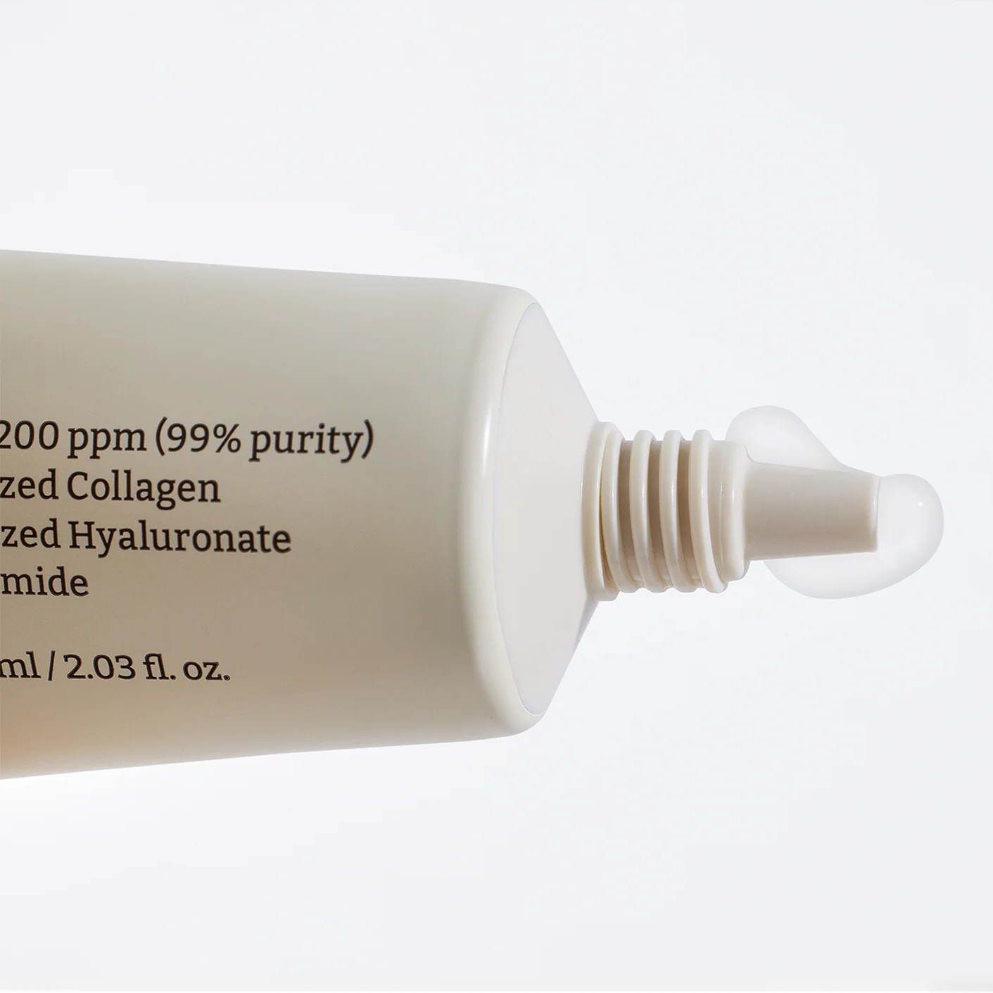 Skincare serum bottle with text on a white background