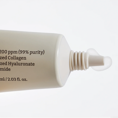Skincare serum bottle with text on a white background