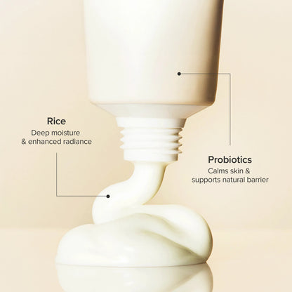 Cosmetic bottle with text highlighting rice and probiotics on a beige background
