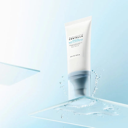 Skincare tube with water droplets on a light blue background