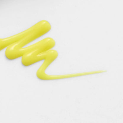 Smeared yellow substance on a white background